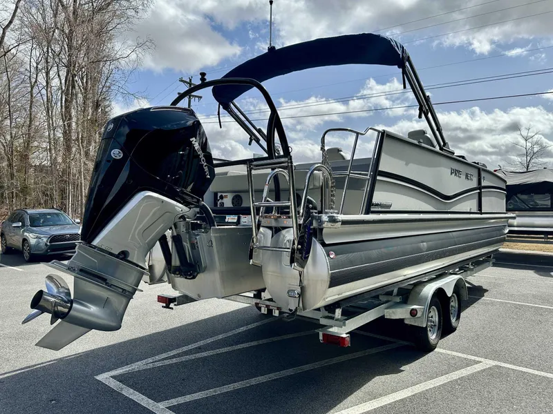 Slide: The Image of 2024 Premier 250 Solaris RL pontoon boat on trailer, featuring a powerful outboard motor. - 6