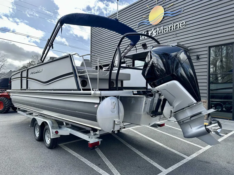 Slide: The Image of 2024 Premier 250 Solaris RL pontoon boat on trailer outside dealership. - 8