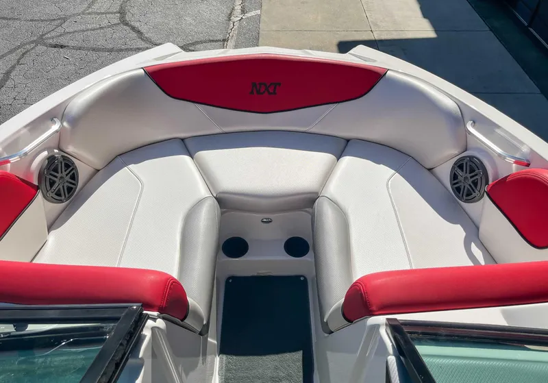 Slide: The Image of 2015 MasterCraft NXT20 boat interior with red and white seating and speakers. - 10