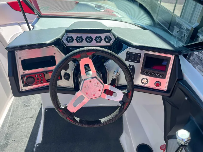 Slide: The Image of Steering wheel and dashboard of a 2015 MasterCraft NXT20 boat. - 14