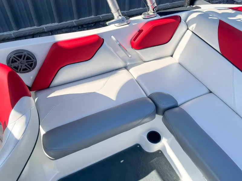 Slide: The Image of 2015 MasterCraft NXT20 boat interior with red and white seating, JL Audio speaker. - 16