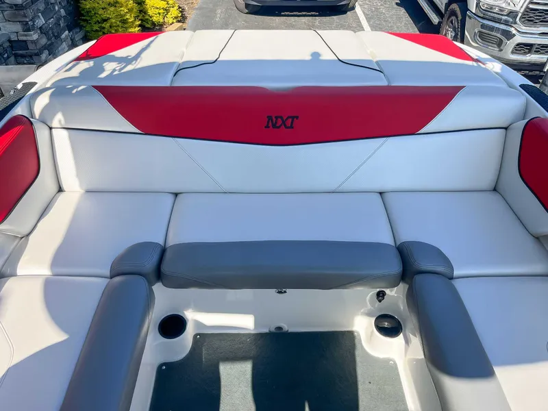 Slide: The Image of 2015 MasterCraft NXT20 boat interior with red and gray seating. - 17