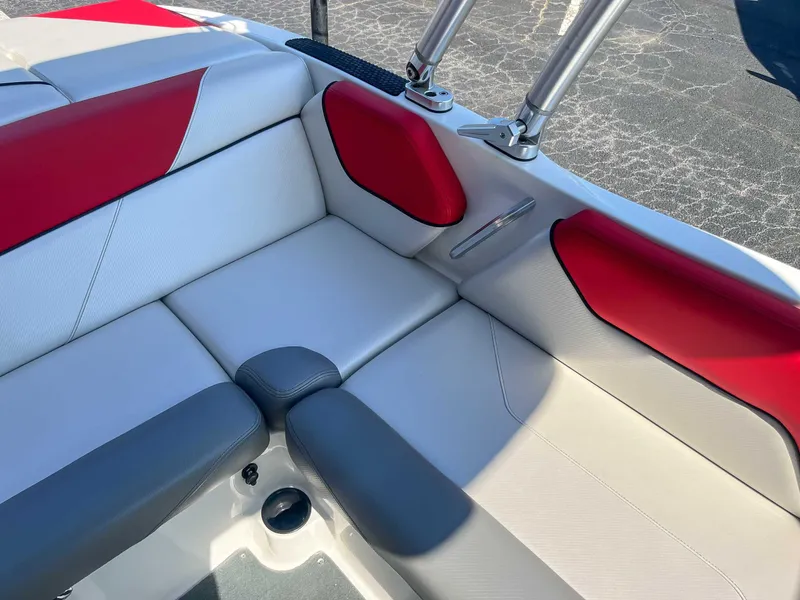 Slide: The Image of 2015 MasterCraft NXT20 boat interior with red and gray seating. - 18