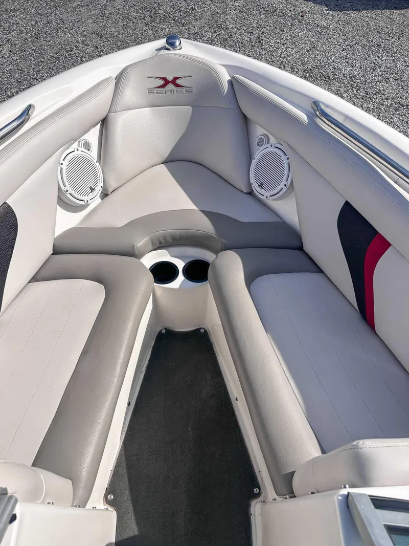 Slide: The Image of 2008 MasterCraft X1 boat interior with cushioned seating and built-in speakers. - 12