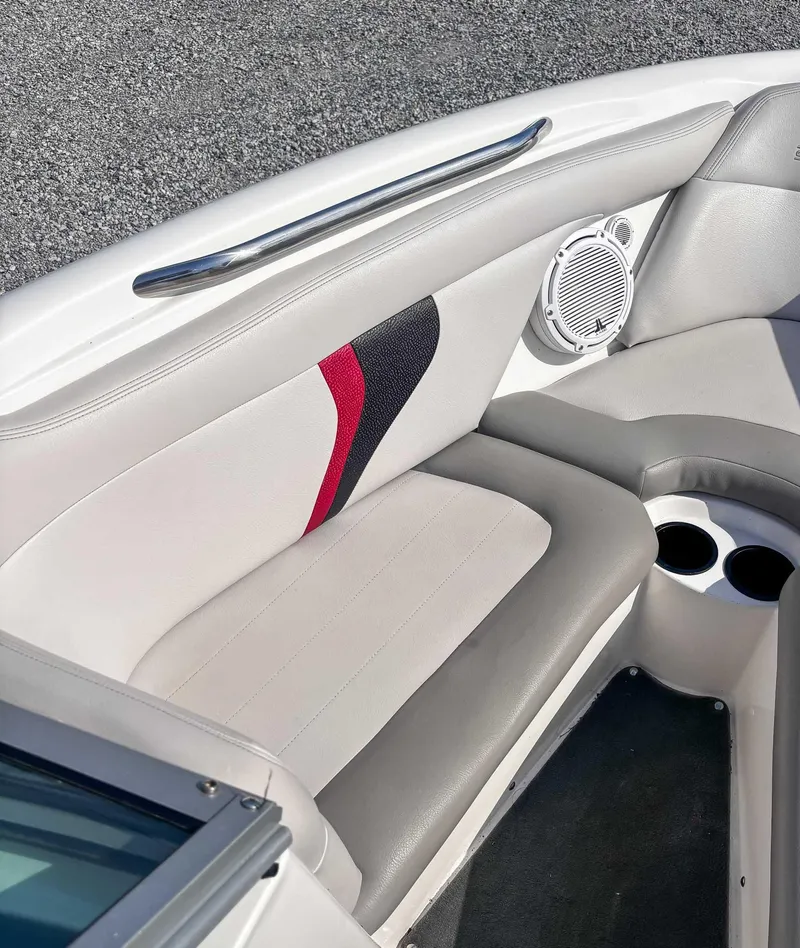 Slide: The Image of 2008 MasterCraft X1 boat interior with cushioned seating and speaker. - 13