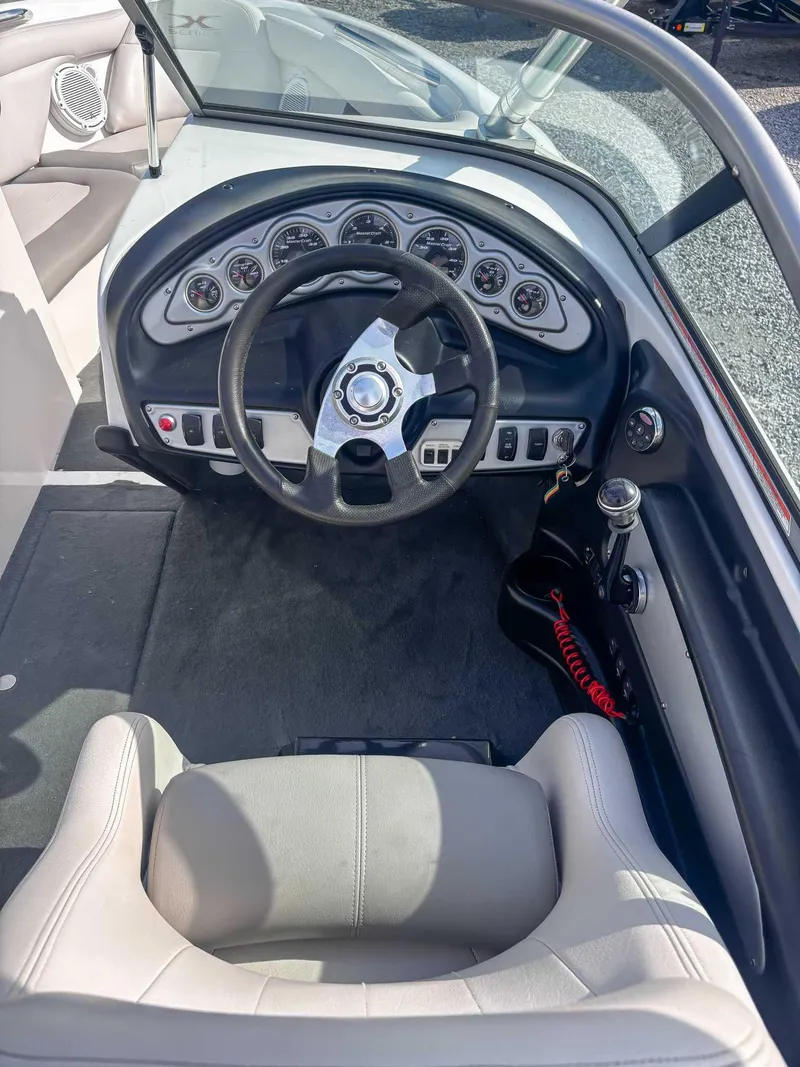 Slide: The Image of 2008 MasterCraft X1 boat dashboard with steering wheel and gauges. - 16