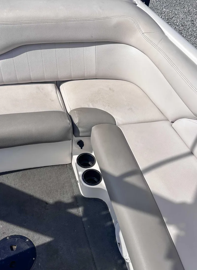 Slide: The Image of 2008 MasterCraft X1 boat interior with gray and white seating and cup holders. - 18