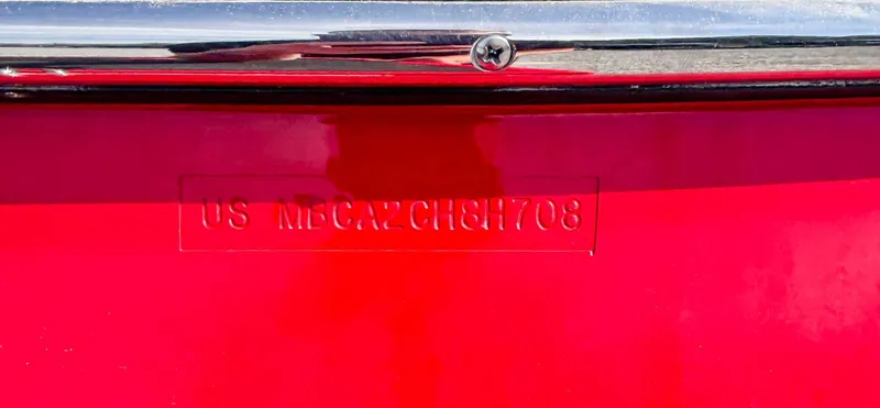 Slide: The Image of 2008 MasterCraft X1 boat hull identification number on red surface. - 20