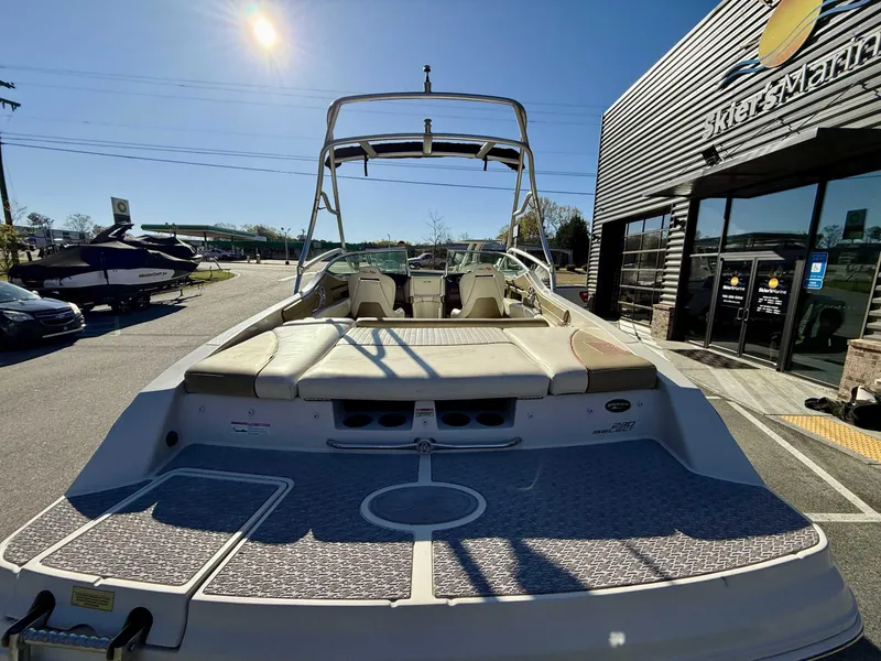 Slide: The Image of 2007 Sea Ray 230 Select boat at Skier's Marine dealership under bright sunlight. - 11