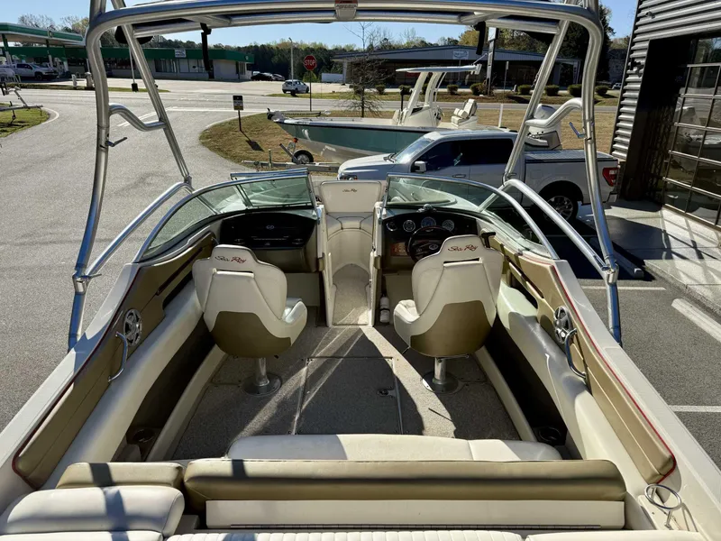 Slide: The Image of 2007 Sea Ray 230 Select boat interior with seating and dashboard, parked outdoors. - 13