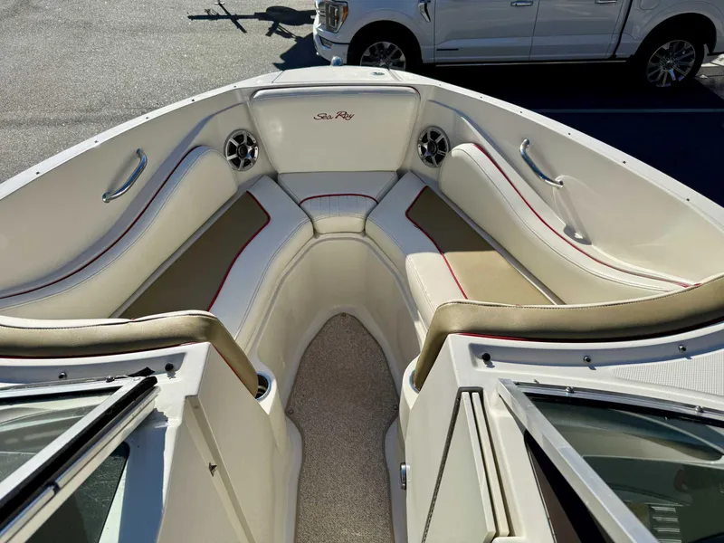 Slide: The Image of 2007 Sea Ray 230 Select boat interior with white and beige seating, red accents. - 14