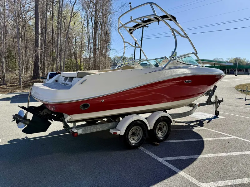 Slide: The Image of 2007 Sea Ray 230 Select boat on trailer, parked in a wooded area. - 6