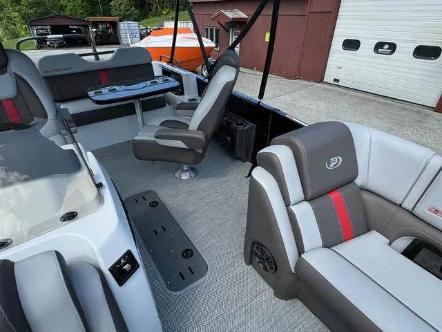Slide: The Image of 2024 Princecraft Vogue® 23 RL boat interior with gray seating and red accents. - 14