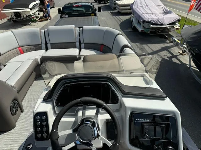 Slide: The Image of 2024 Princecraft Vogue® 23 RL boat interior with steering console and seating area. - 19