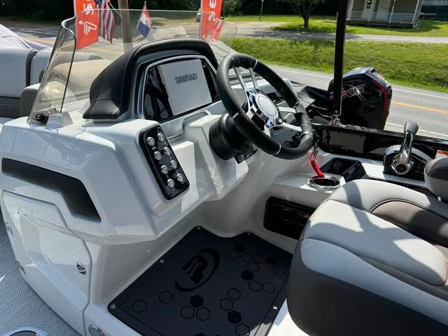 Slide: The Image of 2024 Princecraft Vogue® 23 RL boat dashboard with steering wheel and controls. - 21