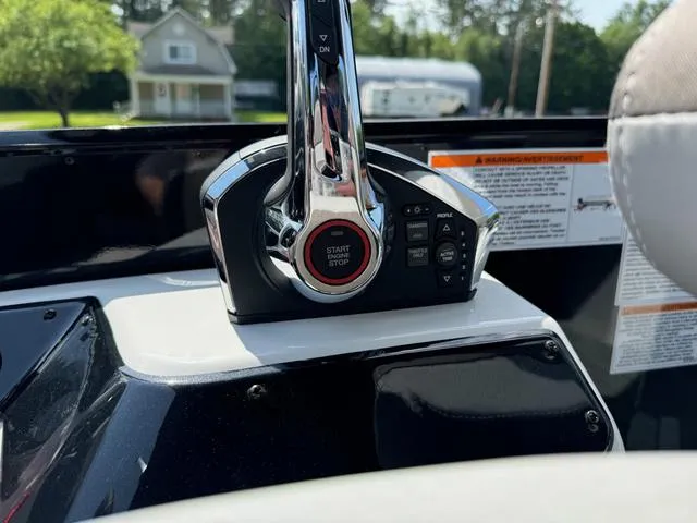 Slide: The Image of 2024 Princecraft Vogue® 23 RL boat throttle control with start/stop button, close-up view. - 22