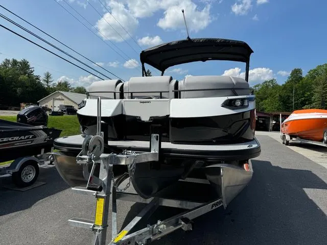 Slide: The Image of 2024 Princecraft Vogue® 23 RL pontoon boat on trailer, under a clear blue sky. - 3