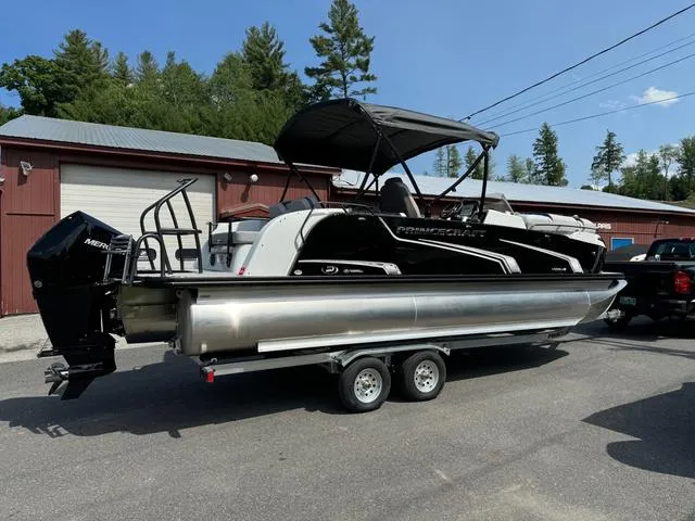 Slide: The Image of 2024 Princecraft Vogue® 23 RL pontoon boat on trailer, parked outdoors near a building. - 6