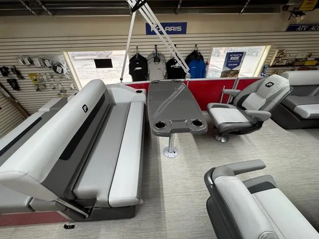 Slide: The Image of 2025 Princecraft Vectra 21 RL 115HP boat interior with seating and table in showroom. - 11