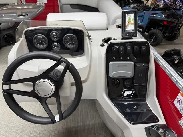 Slide: The Image of 2025 Princecraft Vectra 21 RL 115HP boat dashboard with steering wheel and navigation system. - 12