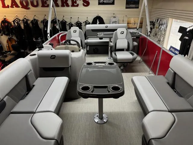 Slide: The Image of 2025 Princecraft Vectra 21 RL 115HP pontoon boat interior with gray seating and central table. - 6