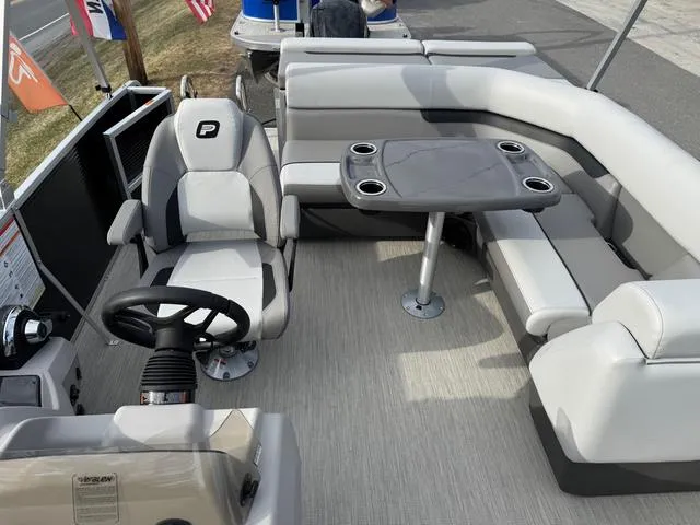 Slide: The Image of 2025 Princecraft SportFisher 21-2S 90HP boat interior with seating and table. - 11