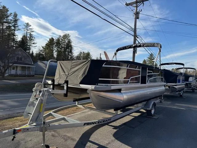 Slide: The Image of 2025 Princecraft SportFisher 21-2S 90HP pontoon boat on trailer, parked roadside. - 5