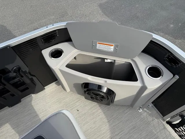 Slide: The Image of 2025 Princecraft SportFisher 21-2S boat interior with cup holders and storage compartment. - 9