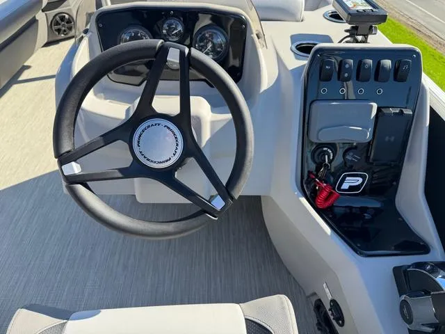 Slide: The Image of 2025 Princecraft Vectra 21 L 90HP boat dashboard with steering wheel and control panel. - 8