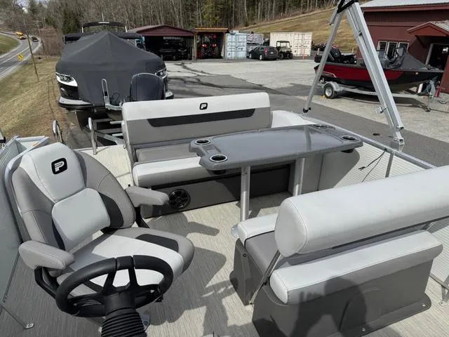 Slide: The Image of 2025 Princecraft Vectra 21 RL 150HP pontoon boat interior with seating and steering wheel. - 10
