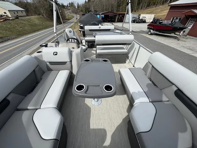 Slide: The Image of 2025 Princecraft Vectra 21 RL 150HP pontoon boat interior with gray seating and table. - 11