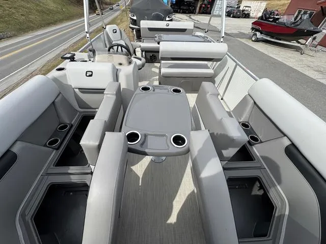 Slide: The Image of 2025 Princecraft Vectra 21 RL 150HP pontoon boat interior with seating and table. - 12