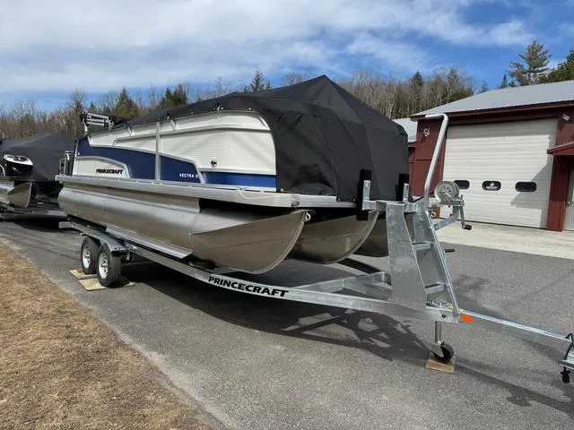 Slide: The Image of 2025 Princecraft Vectra 21 RL 150HP pontoon boat on trailer, covered, outdoors. - 6