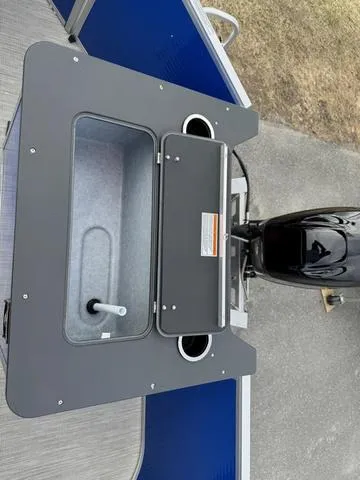 Slide: The Image of 2025 Princecraft Jazz 19-4S 60HP boat with open storage compartment and motor. - 11