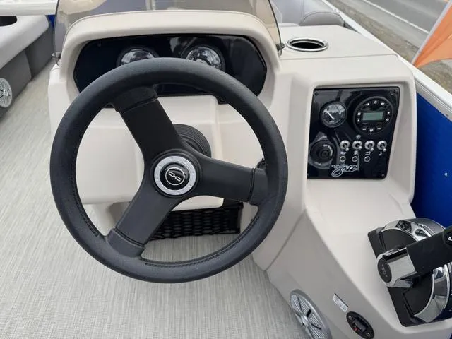 Slide: The Image of 2025 Princecraft Jazz 19-4S boat dashboard with steering wheel and control panel. - 12