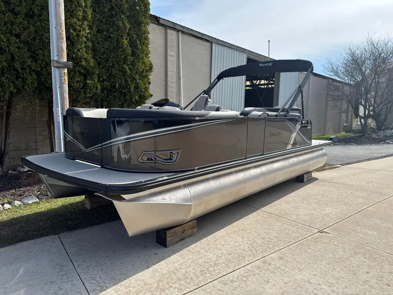 Slide: The Image of 2025 Tahoe Pontoon LTZ Cruise Rear Bench on display outdoors. - 2