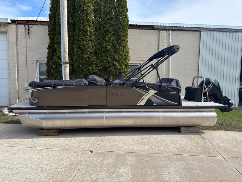 Slide: The Image of 2025 Tahoe Pontoon LTZ Cruise Rear Bench, docked outdoors, side view. - 3