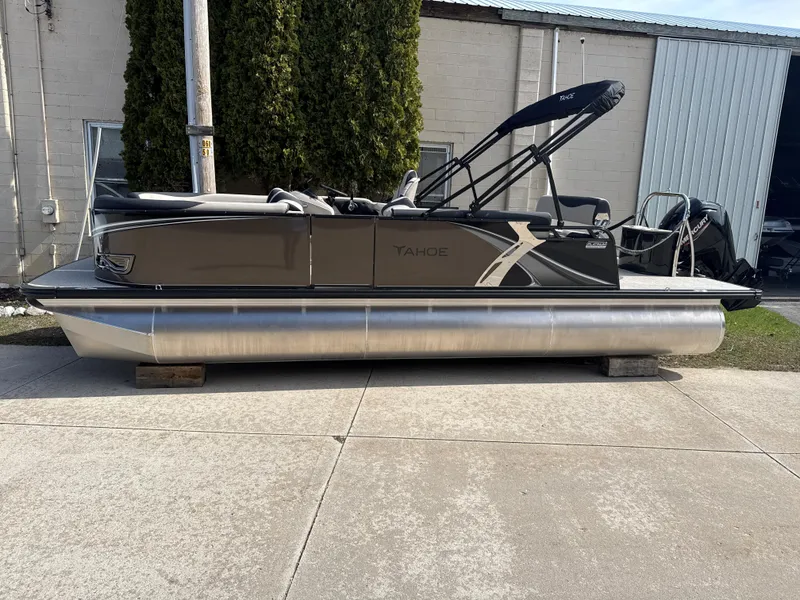 Slide: The Image of 2025 Tahoe Pontoon LTZ Cruise Rear Bench, sleek design, parked outdoors on concrete. - 6