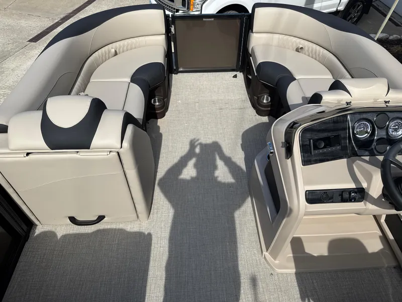 Slide: The Image of 2025 Tahoe Pontoon LTZ Cruise Rear Bench with beige and black seating, spacious interior. - 9