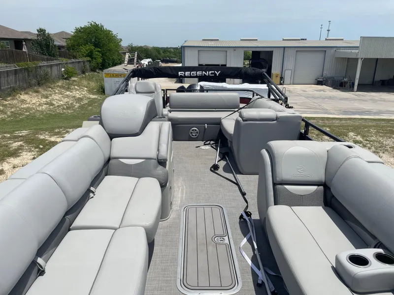 Slide: The Image of 2023 Regency 250 DL3 pontoon boat with spacious seating and modern design. - 13