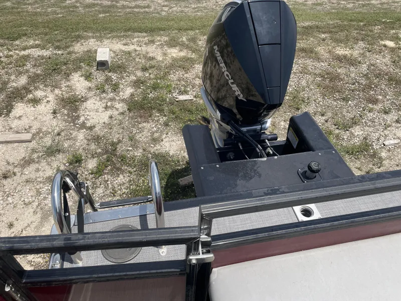 Slide: The Image of 2023 Regency 250 DL3 boat with Mercury outboard motor, viewed from the deck. - 17