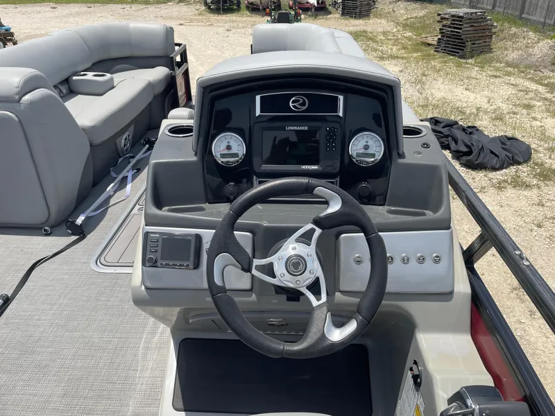 Slide: The Image of 2023 Regency 250 DL3 boat dashboard with steering wheel and control panel. - 19