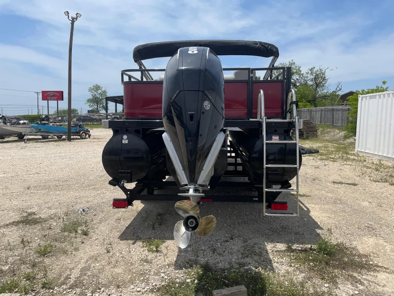 Slide: The Image of 2023 Regency 250 DL3 pontoon boat, rear view with outboard motor and ladder. - 4