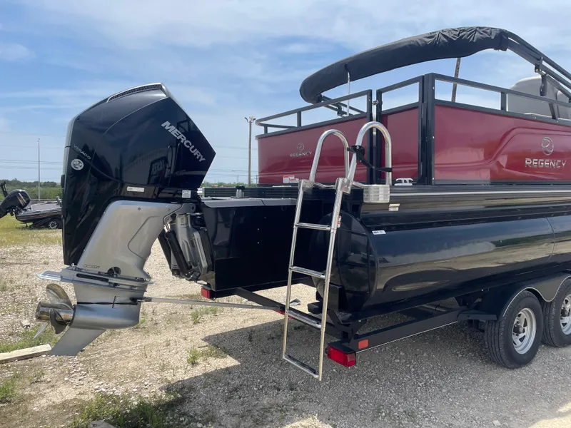 Slide: The Image of 2023 Regency 250 DL3 pontoon boat with Mercury outboard motor and trailer. - 5