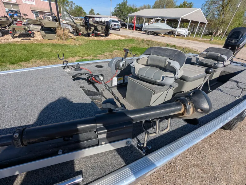 Slide: The Image of 2017 Tracker Panfish 16 boat with seating and equipment, parked outdoors on a sunny day. - 12