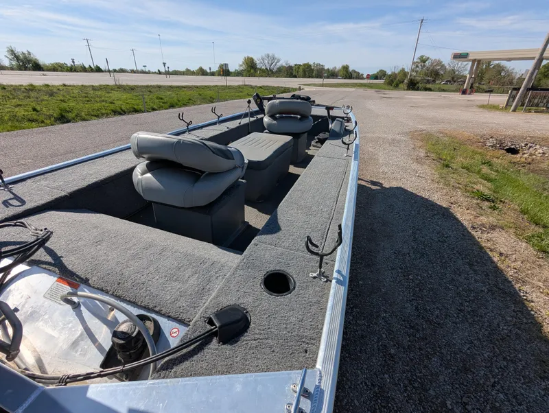 Slide: The Image of 2017 Tracker Panfish 16 boat with seating, parked on gravel near a road. - 14