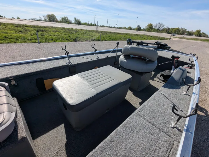Slide: The Image of 2017 Tracker Panfish 16 boat interior with seating and storage on a sunny day. - 15