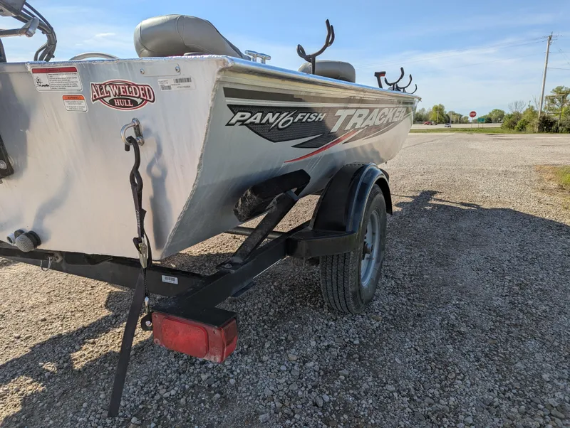 Slide: The Image of 2017 Tracker Panfish 16 boat on trailer, parked on gravel road. - 6