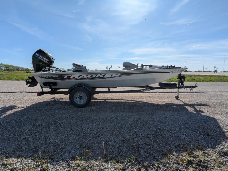 Slide: The Image of 2017 Tracker Panfish 16 boat on trailer under clear blue sky. - 8