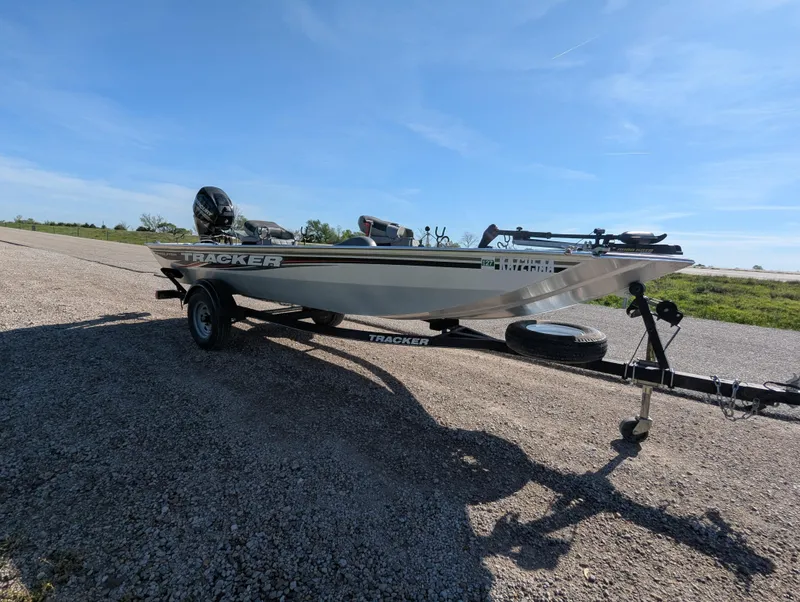 Slide: The Image of 2017 Tracker Panfish 16 boat on trailer under clear blue sky. - 9